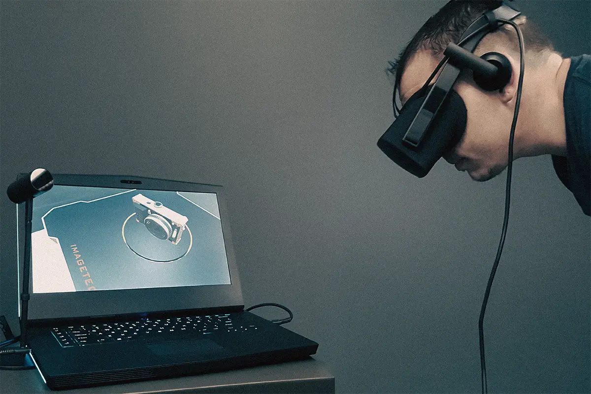 Participant at a workstation wearing a head-mounted display during a VR retail experiment